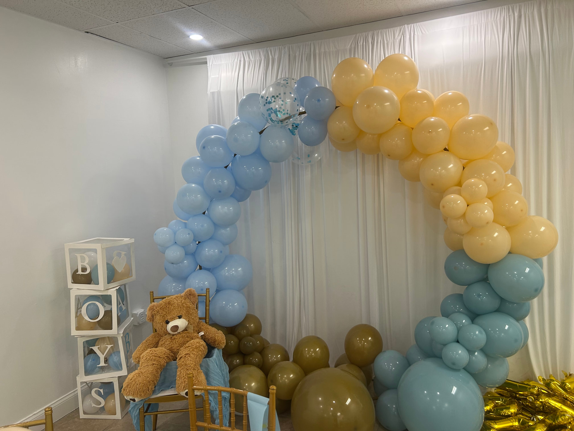 Blue and gold balloon installation for a baby celebration